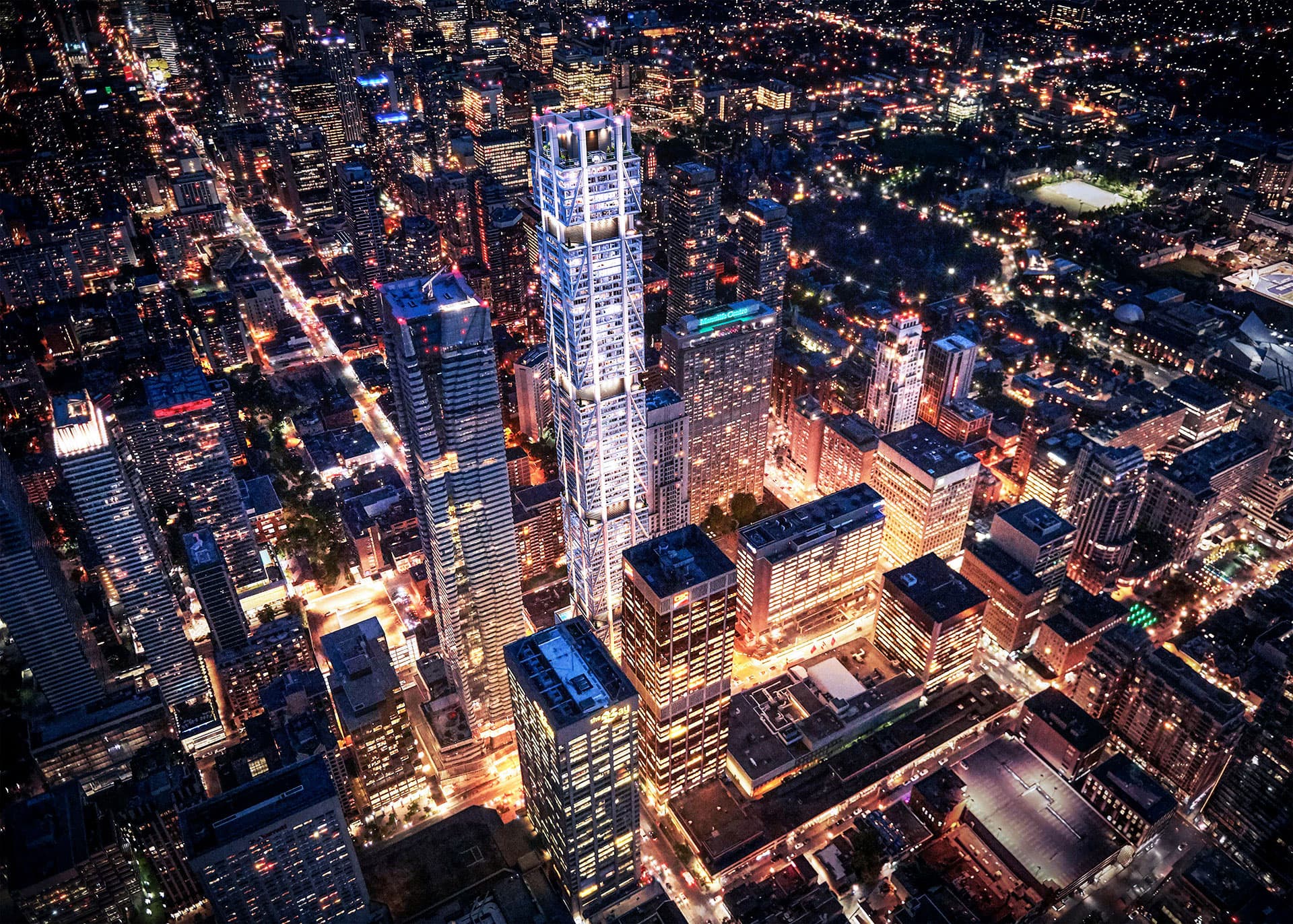 One Bloor West glowing above the Toronto skyline at night