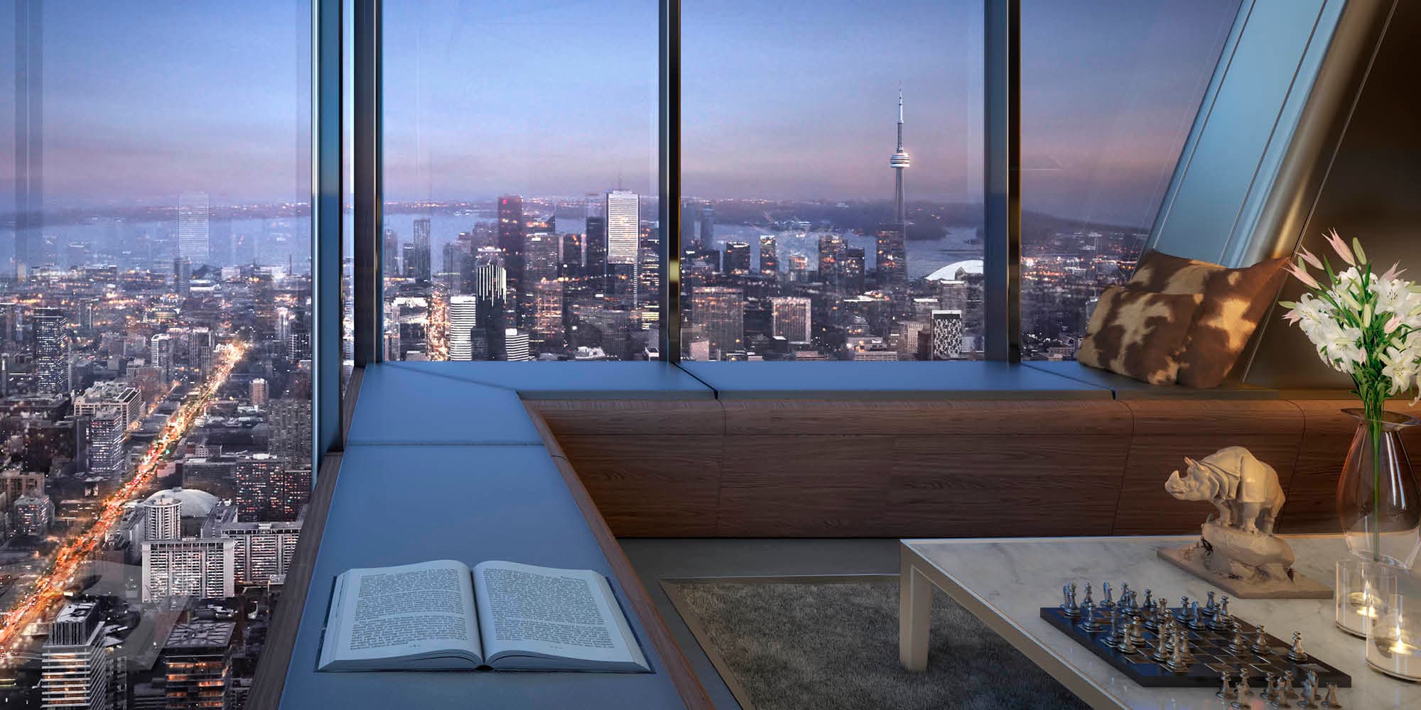 A One Bloor West penthouse at dusk overlooking the city and Lake Ontario